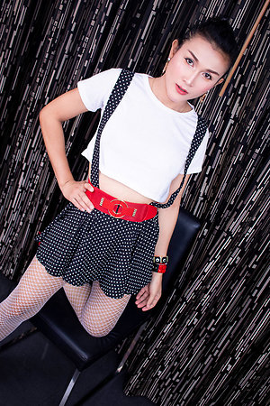 Ladyboy Wallop meet is wearing a sweeping with suspender straps give up shed weight white blouse with arrogant heels.